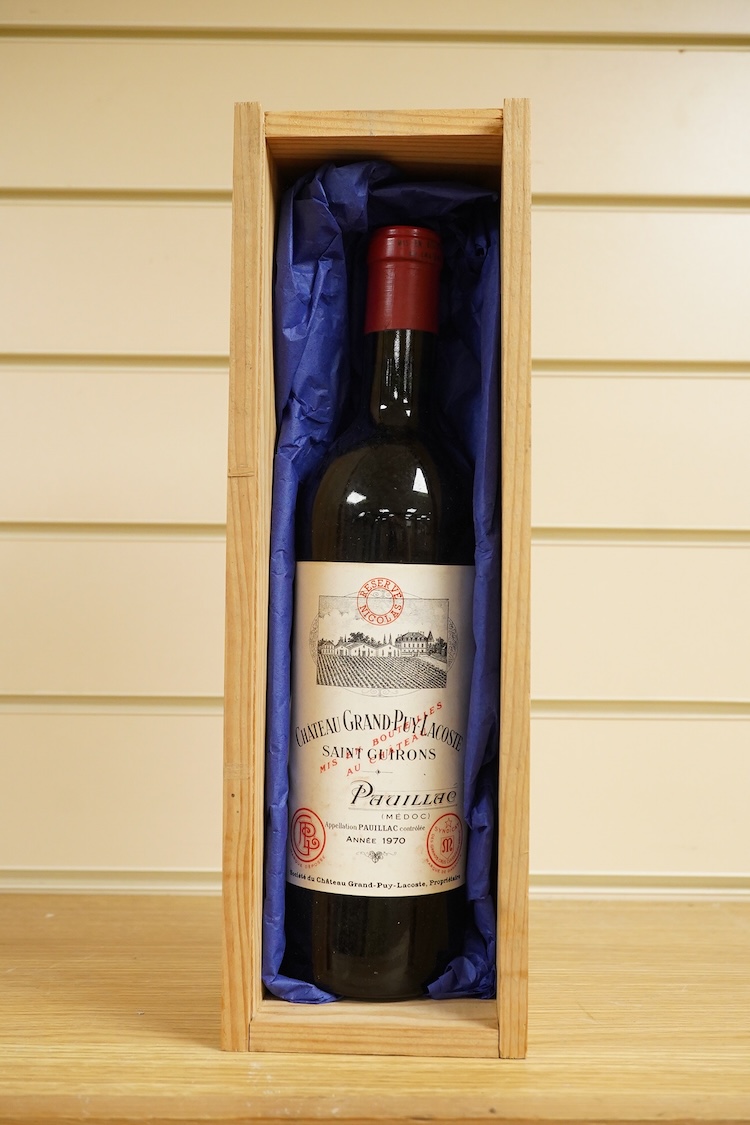 A bottle of Fonseca 1970 vintage port, a bottle of 1970 Chateau Grand-Puy-Lacoste, a litre bottle of Bounty rum and a litre bottle of Harvey’s Bristol Cream